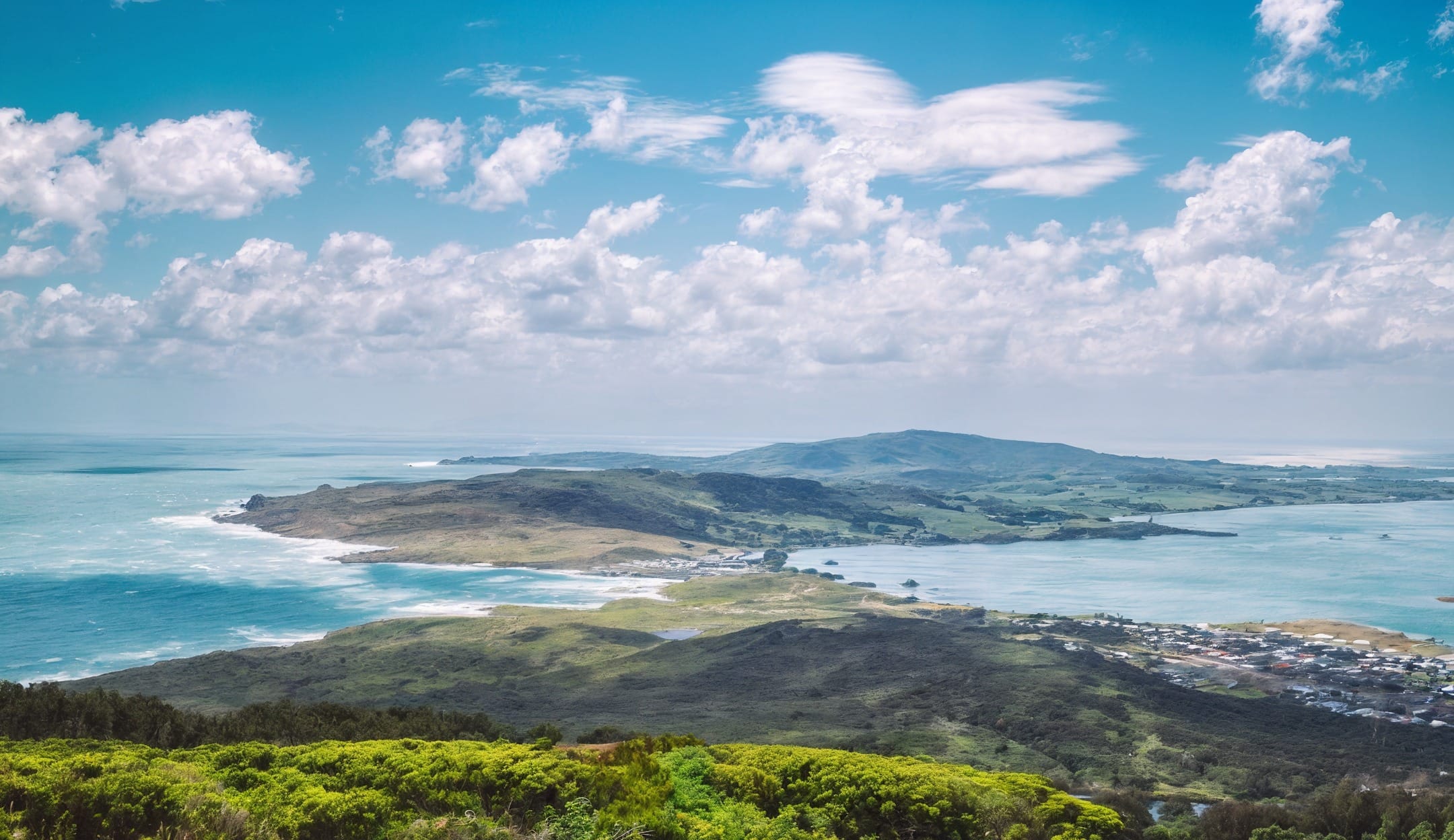 Aerial view of Bluff, Southland showing pristine coastal waters and rolling green hills